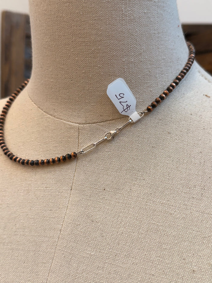 Copper beaded necklace detail with turquoise stone and extender chain with tag