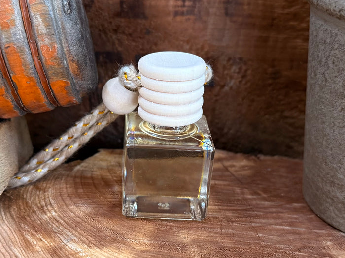 Square glass car diffuser with clear reservoir, gold trim, white aroma pad stack