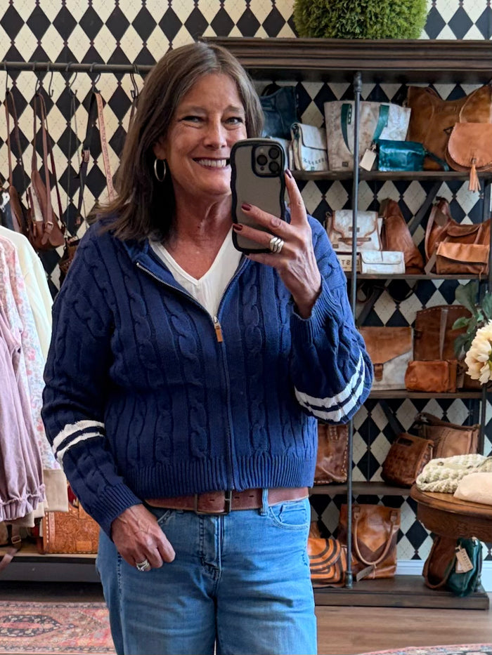 Navy cable-knit varsity hooded cardigan with zip front and striped sleeve cuffs