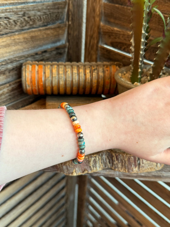 Spiny oyster and turquoise stretchy bracelet worn on wrist