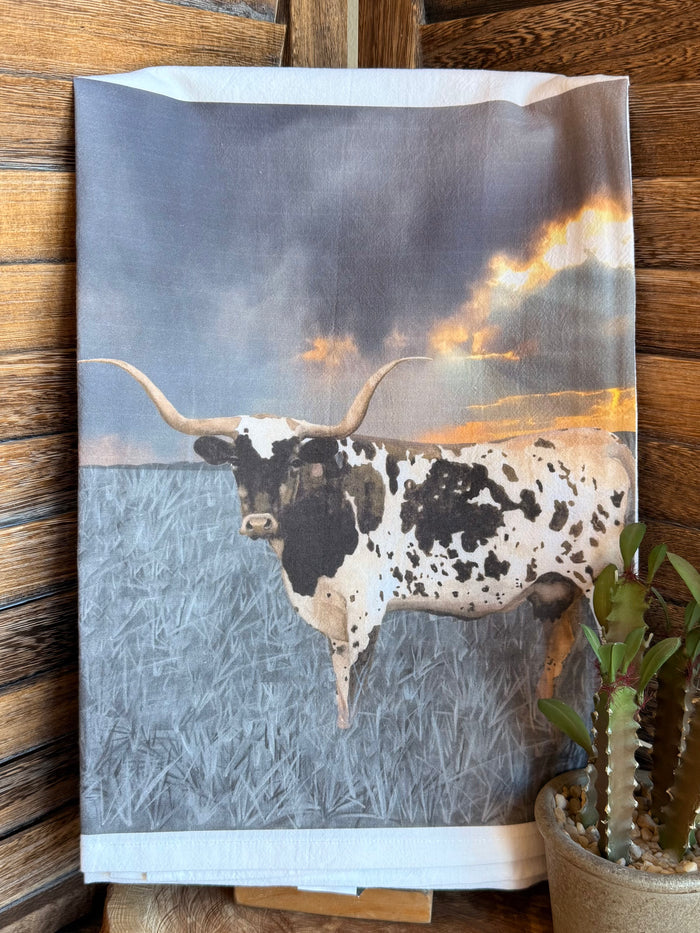 Longhorn watercolor tea towel, black-and-white head centered with warm sunset clouds