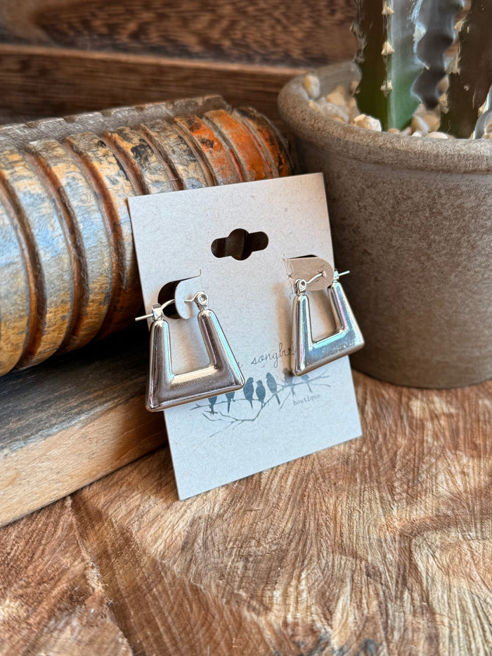 Silver open trapezoid earrings with polished metal and hook-style drop detail