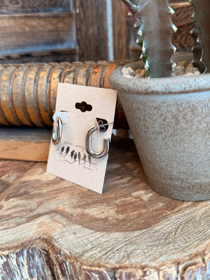 Silver-tone half-hoop stud earrings on card, rounded open hoop with post backing