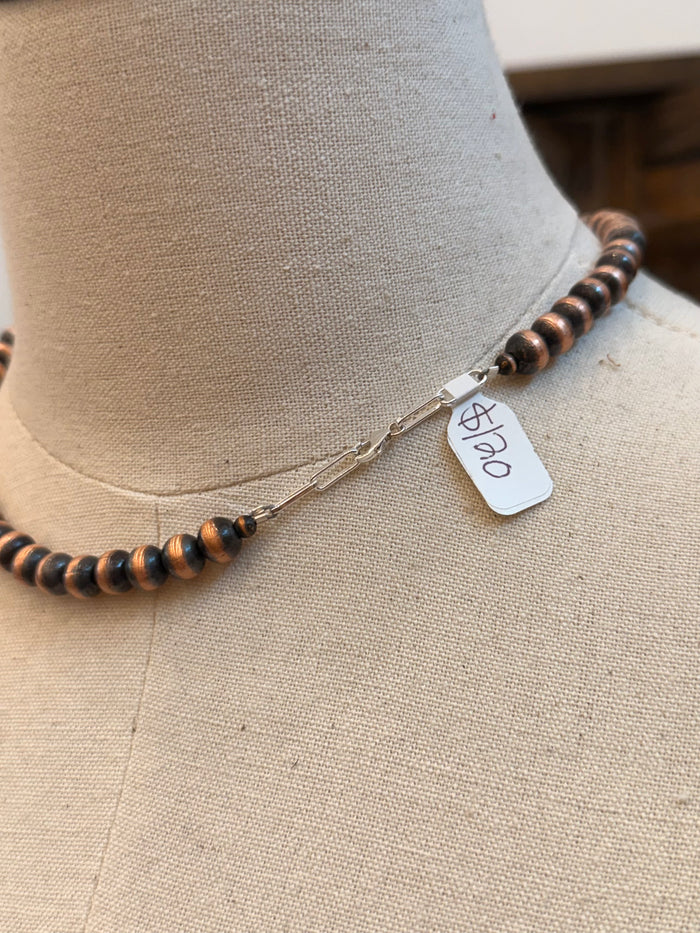 Copper bead necklace clasp with small engraved metal tag