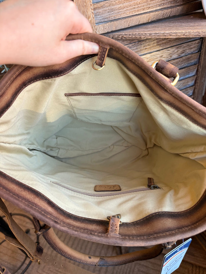 Interior view of cowhide crossbody purse with light lining and zip pocket