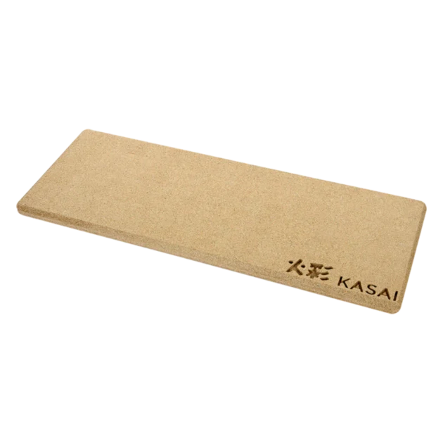 A beige-colored, rectangular heat mat with the brand 'KASAI' written on it, placed on a dark background.