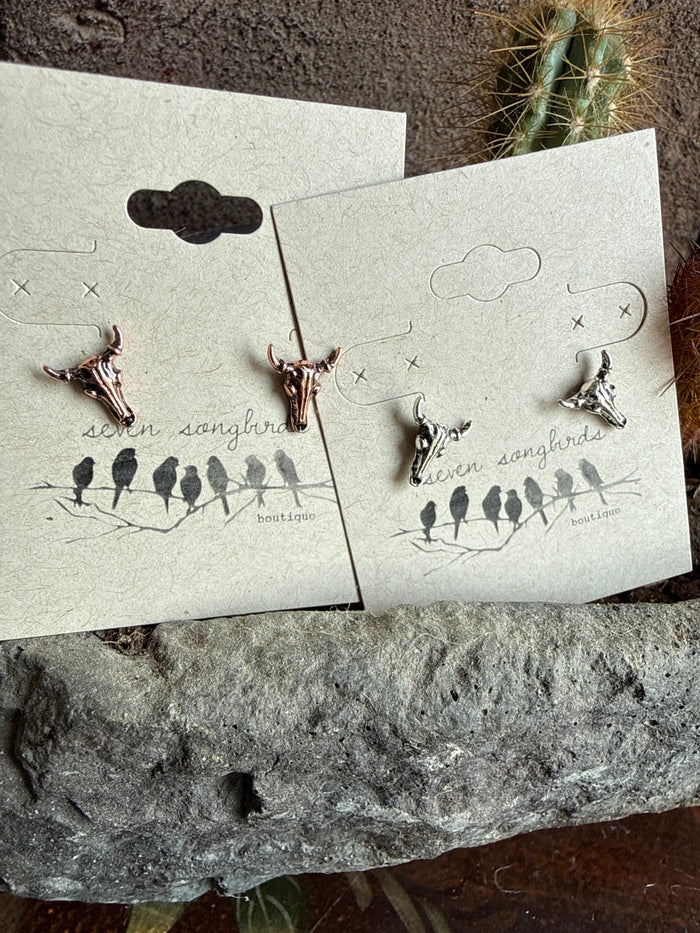 Mini cow skull stud earrings on display card, pair of small silver-tone studs