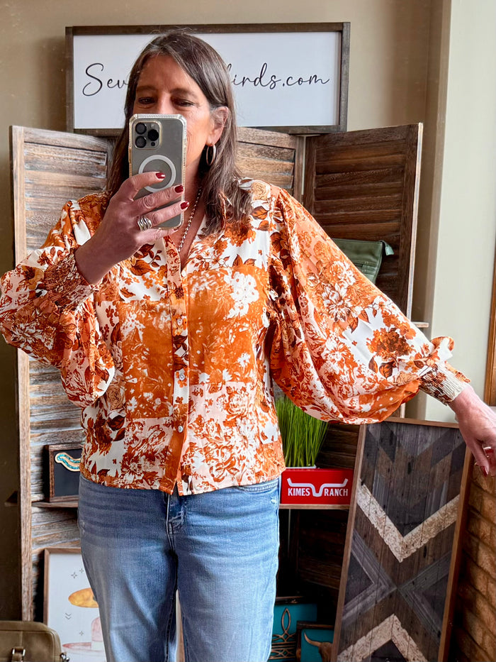Rust orange floral balloon-sleeve blouse with button front and gathered cuffs