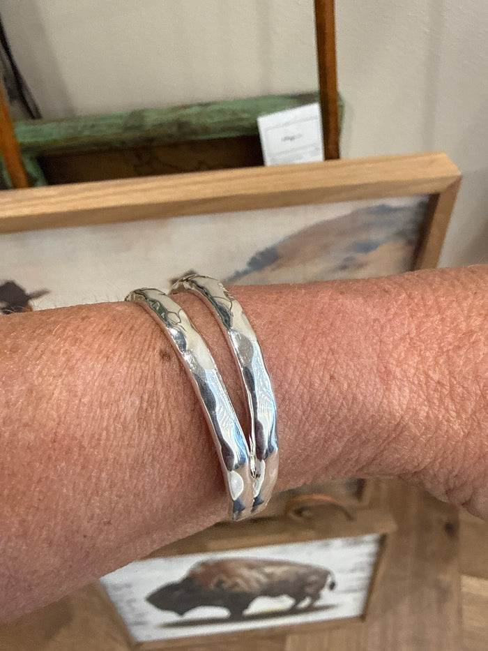 Silpada silver-tone cuff bracelet with three slim bands, close-up on wrist