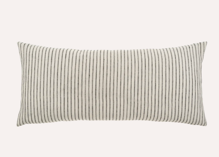 A rectangular linen pillow with a classic ticking stripe pattern in beige and black.