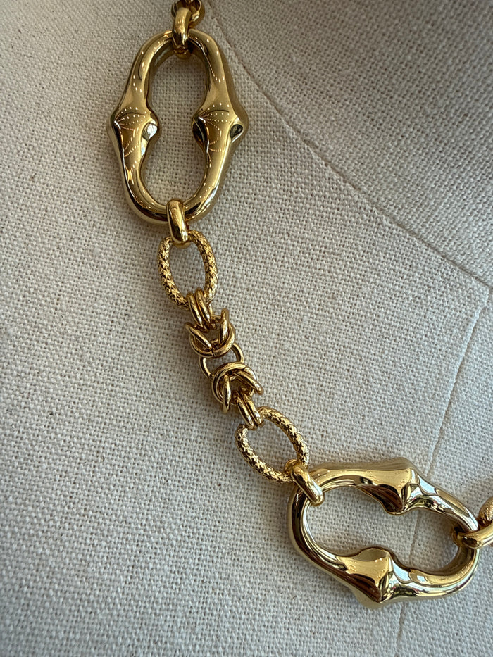 Gold-plated oval link necklace with heart-style links, close-up of chain and clasp