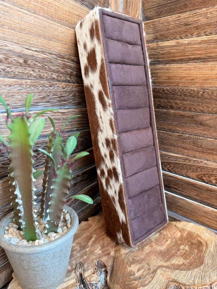 Cowhide ring display box with mauve padded insert and cowhide side panel, upright