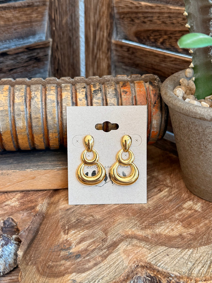 Gold-tone triple round drop stud earrings with oval hoops and stud backing