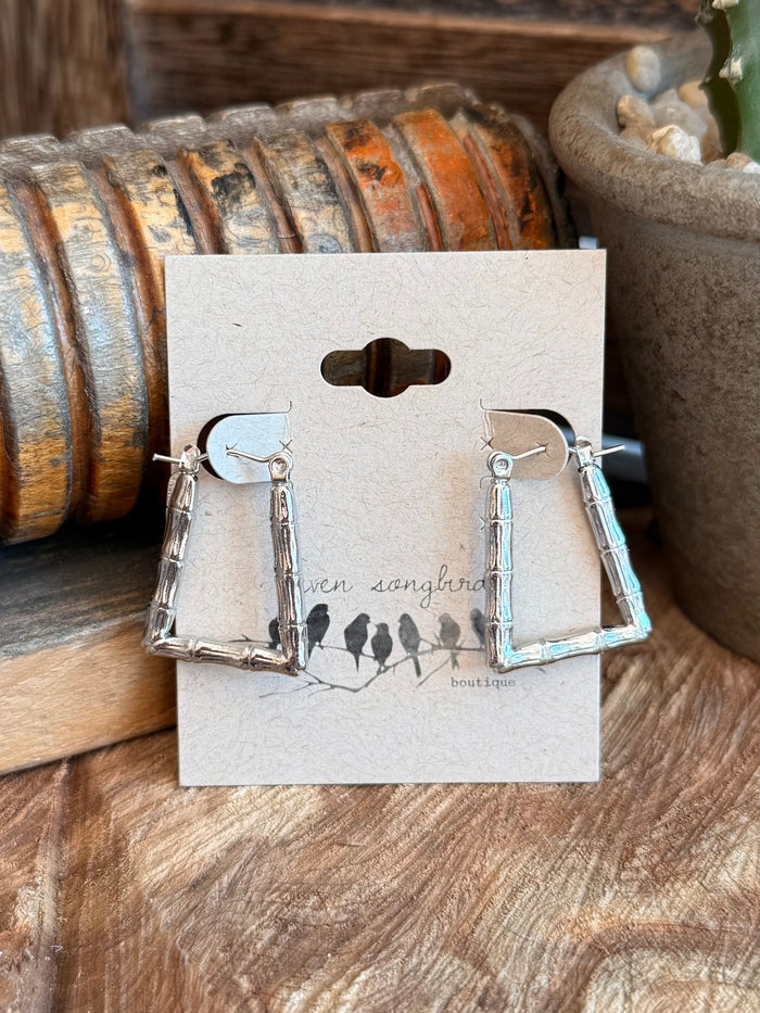 Pair of silver-tone textured trapezoid drop earrings with hook backs, front view