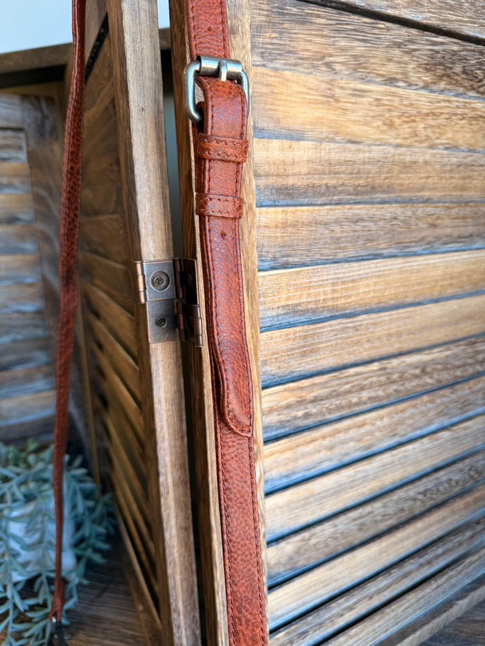 Rusty brown leather crossbody bag strap with metal buckle and D-ring hardware
