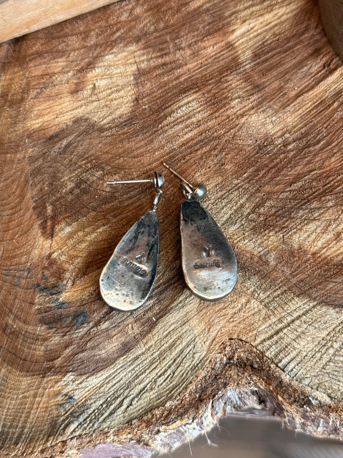 Dark teardrop drop earrings with silver hooks and textured spiny oyster look