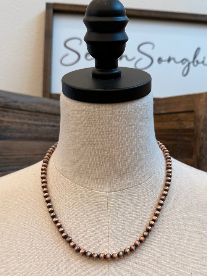Genuine copper bead necklace, evenly spaced round beads on a mannequin