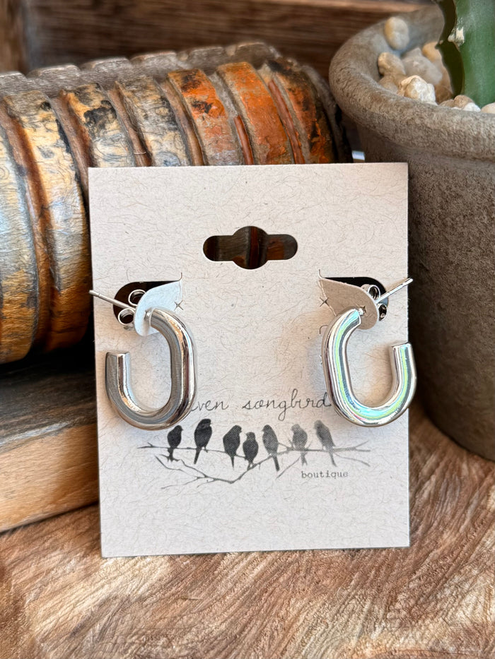 Silver-tone half-hoop stud earrings on card, curved open hoops with shiny iridescent detail