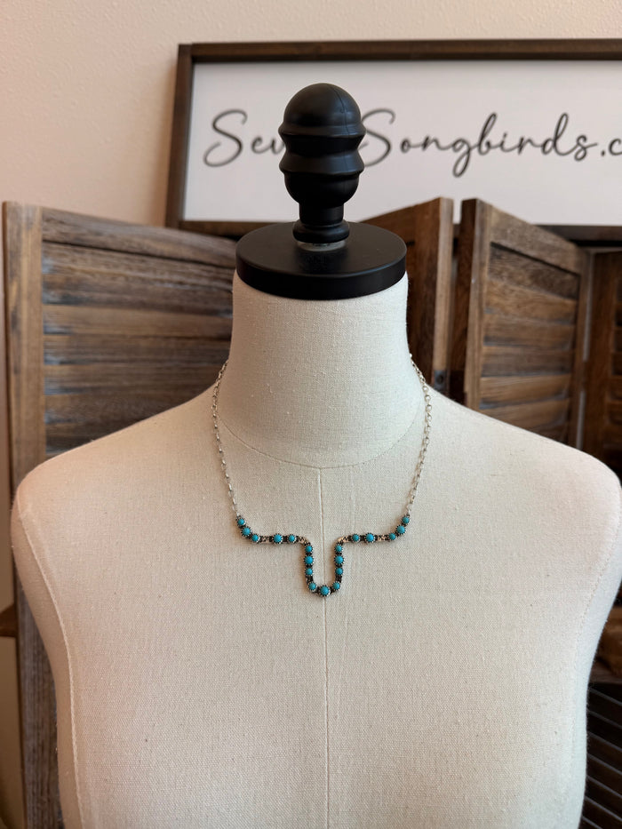 Longhorn outline necklace with turquoise bead pendant on thin gold-tone chain