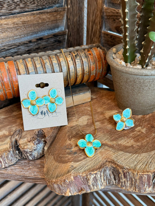 Turquoise blue four-petal floral stud earrings with gold-tone accents