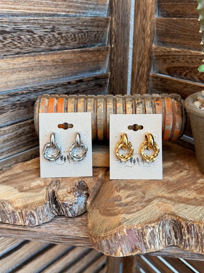 Twisted round stud earrings, paired gold and silver on display cards