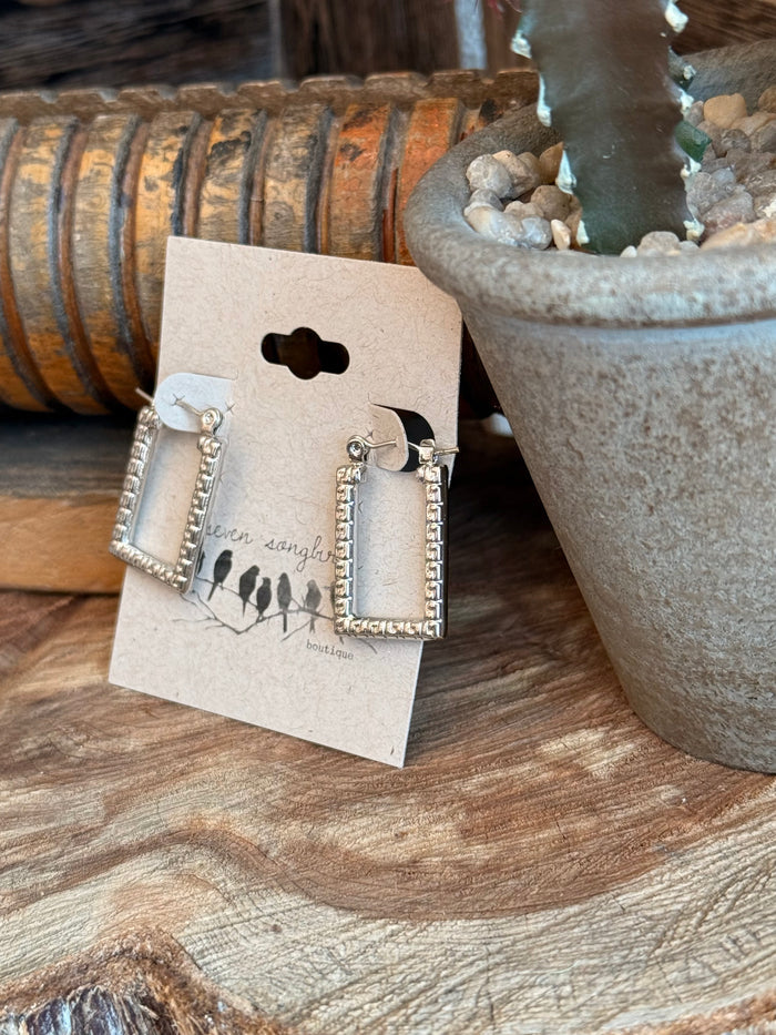 Silver textured trapezoid stud earrings, rectangular frame design with small hoop details.