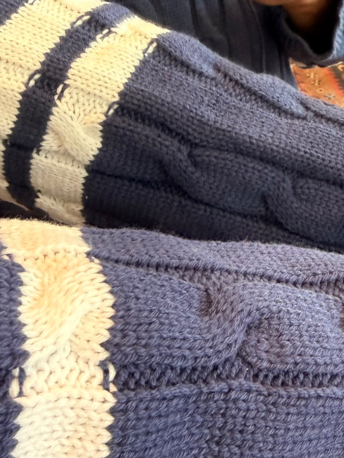 Navy and cream striped cable-knit ribbed cuff detail on a hooded cardigan