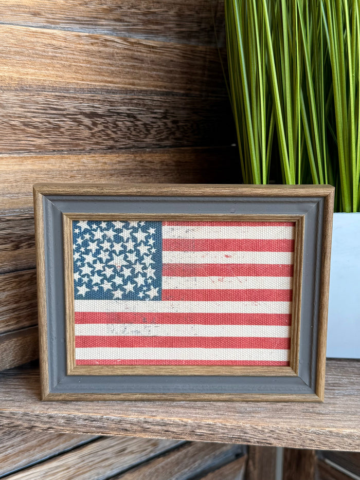 Framed American flag artwork with blue star field and red-and-white stripes, front view