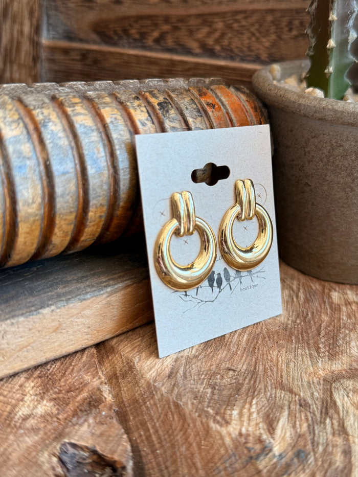 Gold-tone twisted hoop stud earrings, angled view