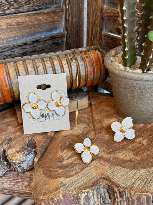 Gold-plated floral earrings with white enamel petals and gold beaded centers