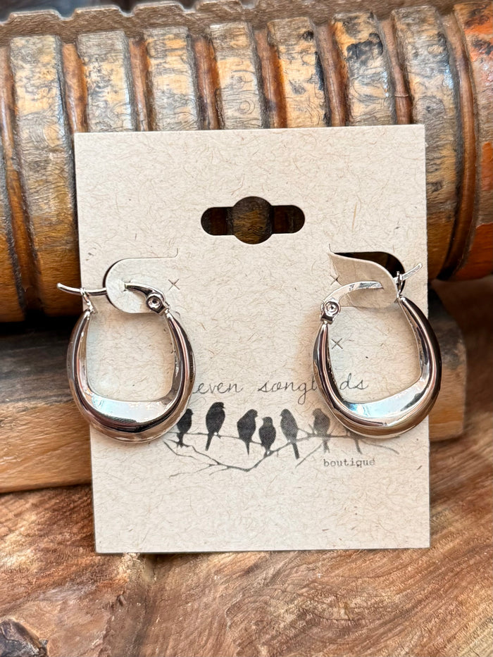 Stainless steel crescent hoop stud earrings, silver-tone, front view with small cross detail