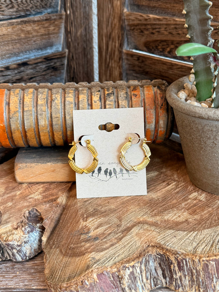 Gold-plated textured wire hoop earrings, shown on display card