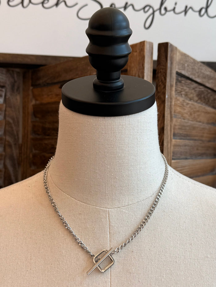 Square toggle clasp necklace with linked silver-toned chain and open square clasp
