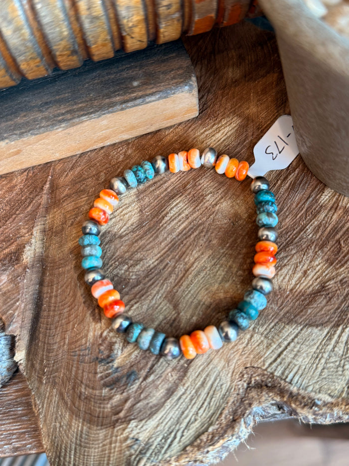 Turquoise, orange, and white bead stretchy bracelet with silver spacers