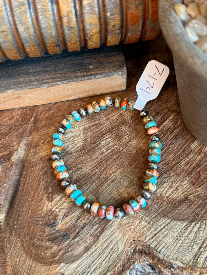 Turquoise bead stretch bracelet with orange speckled discs and small silver pearl beads