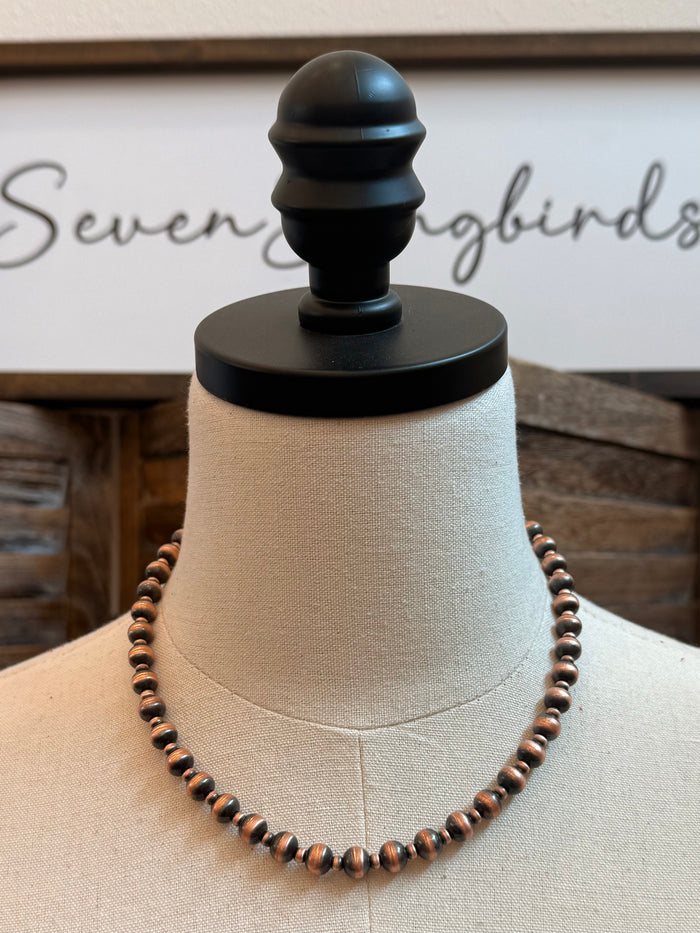 18-inch copper bead necklace with alternating large and small spheres on a mannequin