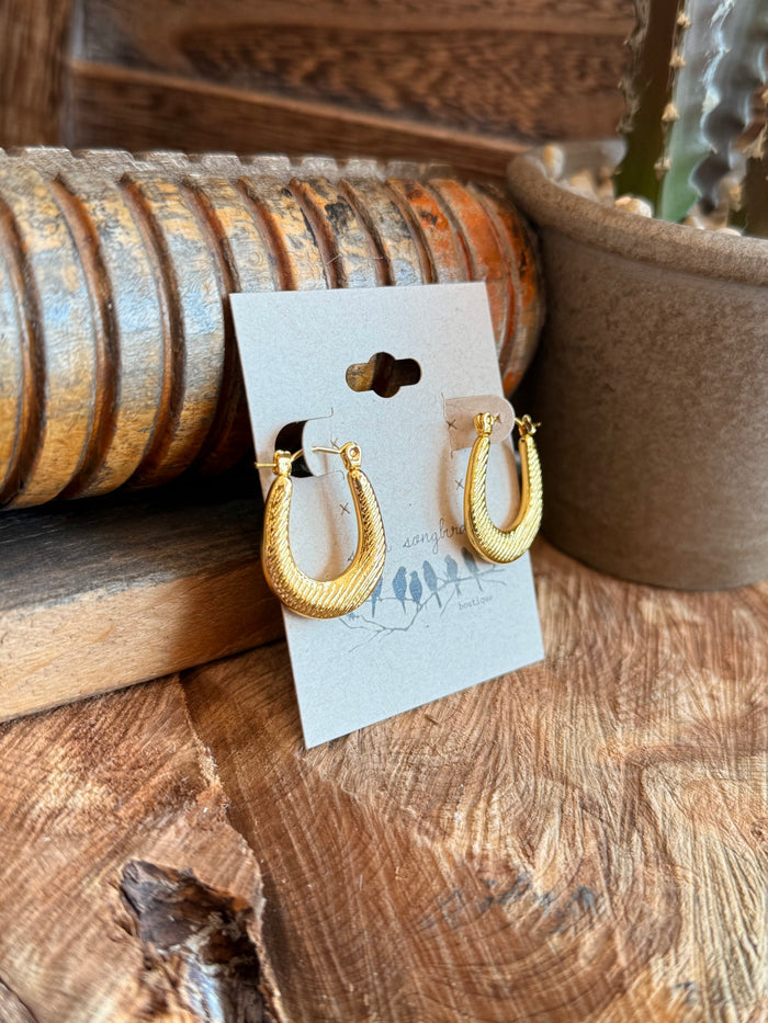 Gold-tone textured half-hoop earrings shown from side with clasp backs