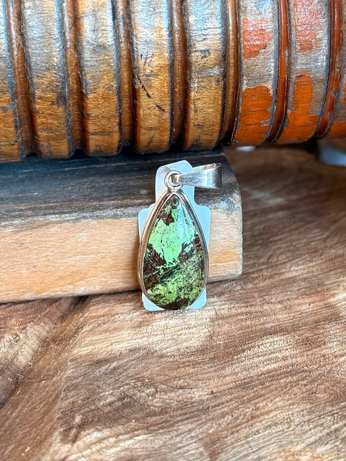 Silver teardrop pendant with green Gaspeite stone in a leaf-like bezel