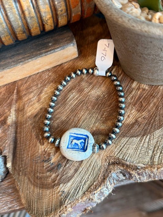 Stretchy beaded bracelet with blue ceramic horse disc and silver-tone bead accents