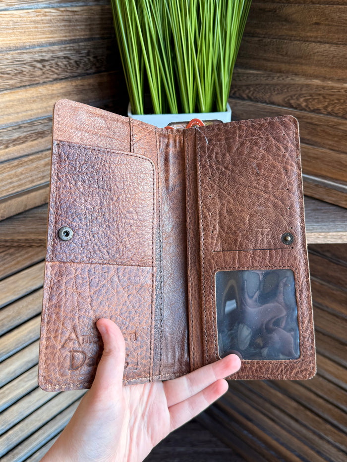 Bifold leather wallet open view with clear ID window, card slots, and snap buttons