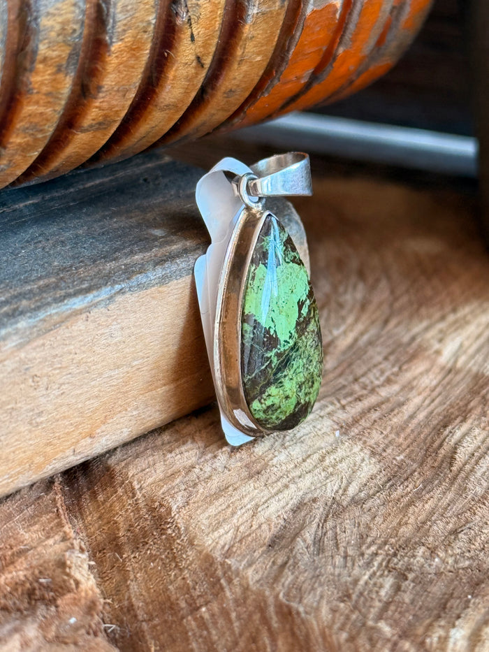Silver Gaspeite teardrop pendant viewed from the side, green stone bezel