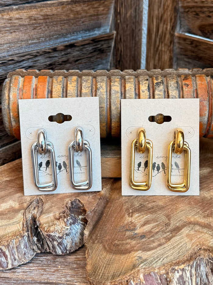 Paperclip stud earrings in silver and gold, shown on pair cards