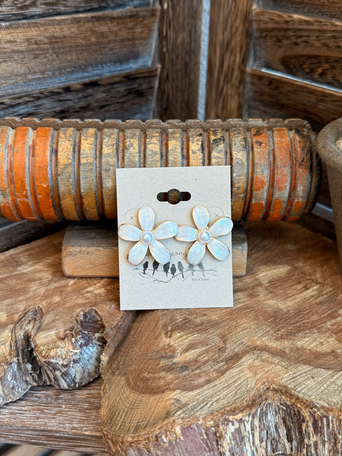 White pearl flower stud earrings with gold-tone posts, layered petals and small dangling charms