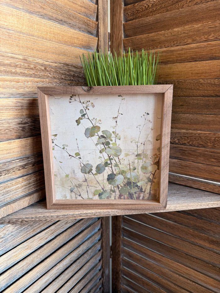 Wood-framed 8x8 leaf landscape artwork with pale background and green foliage