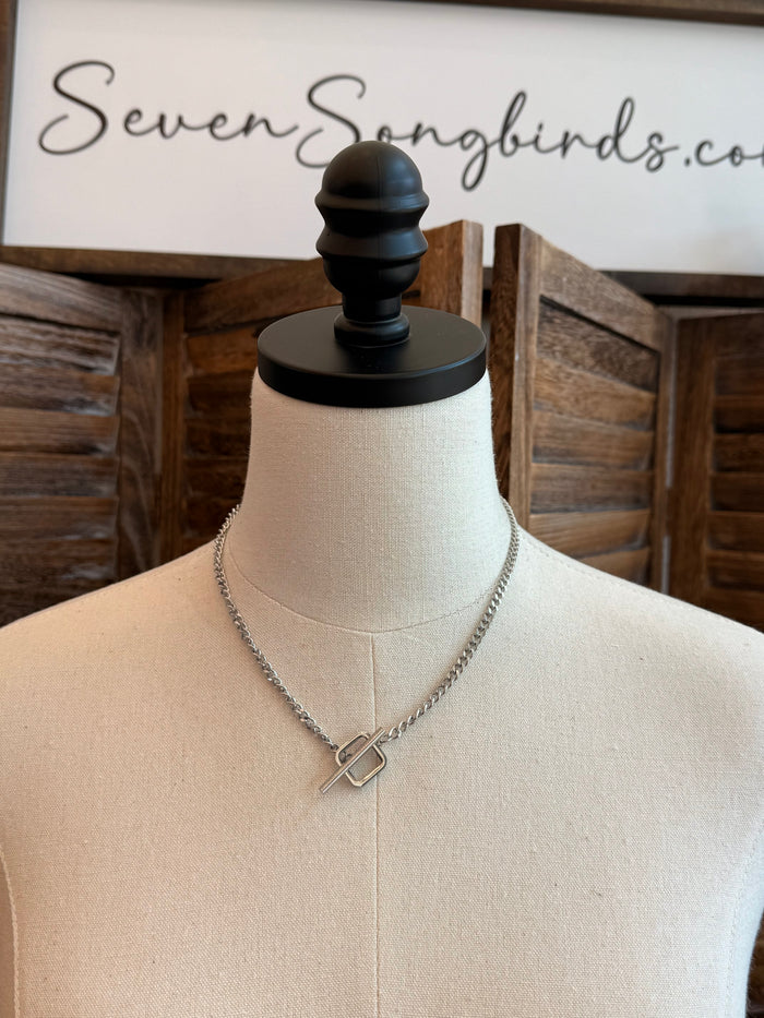 Square toggle clasp necklace with silver-toned chain and square clasp center