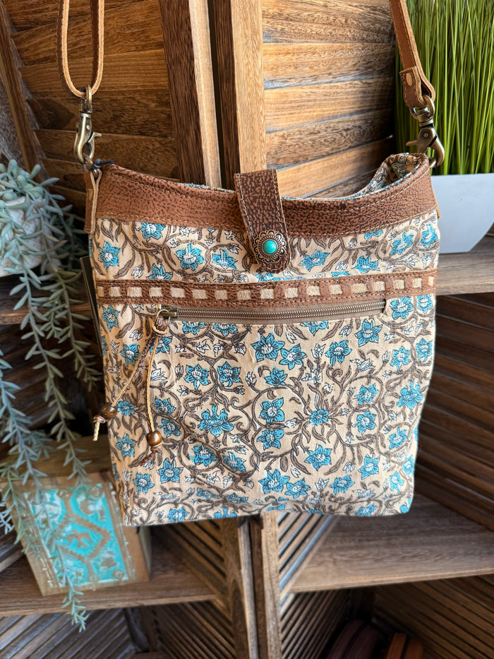 Floral canvas tote with brown leather trim, turquoise pattern, front zip pocket