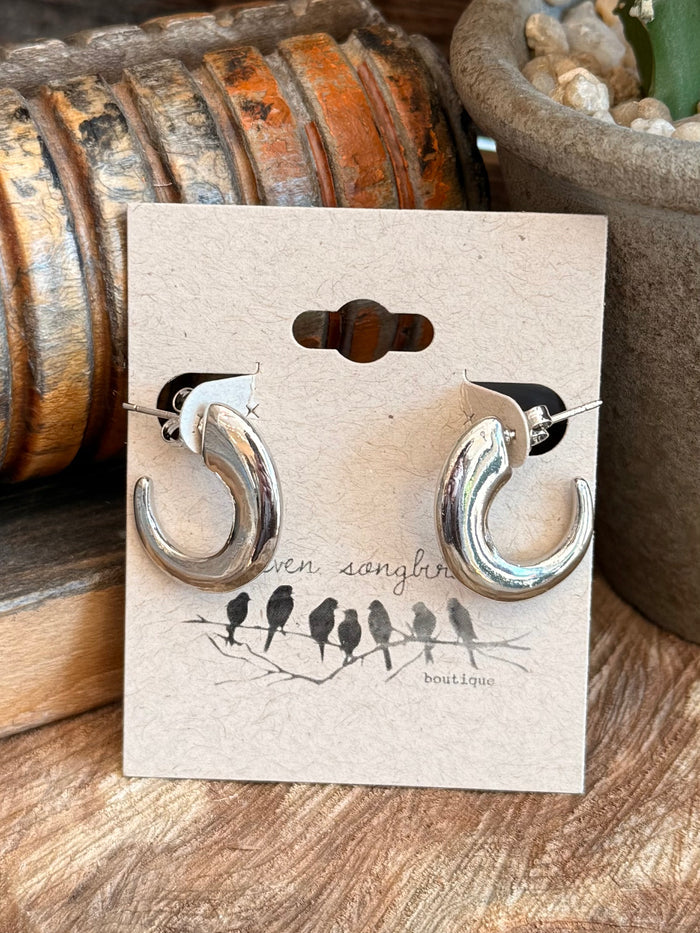 Silver half-curved hoop stud earrings with shiny finish and round post backs