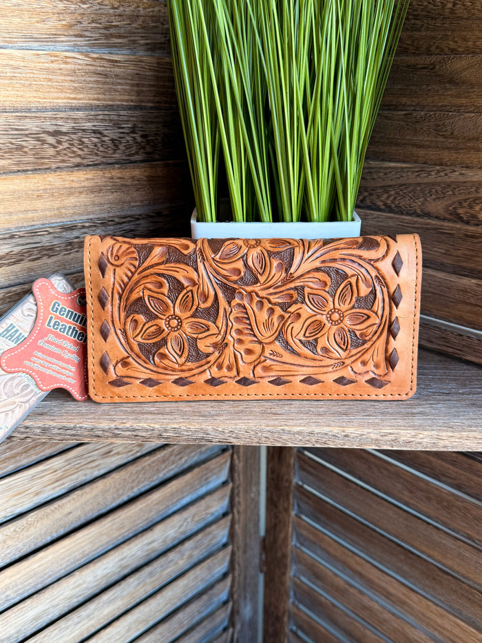 Tooled leather bifold wallet with embossed floral pattern, tan-orange with stitched trim