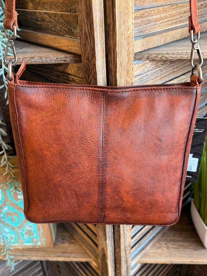 Rusty brown leather crossbody bag front view with top zip closure and wide panels