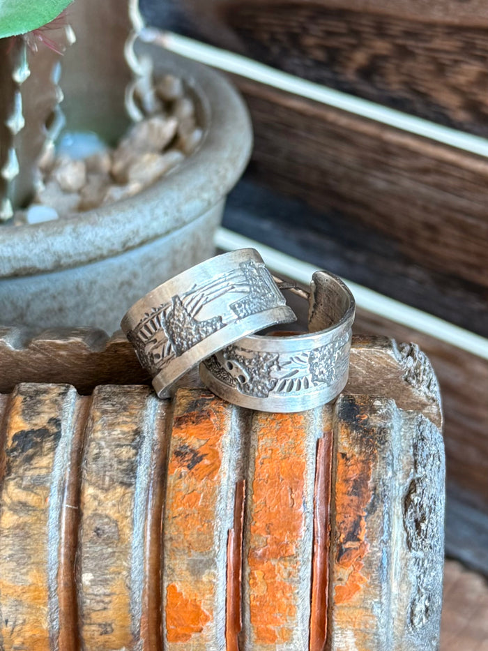 Sterling silver hoop earrings with hammered texture and detailed engraving